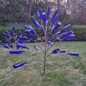 Two blue bottle trees on the lawn