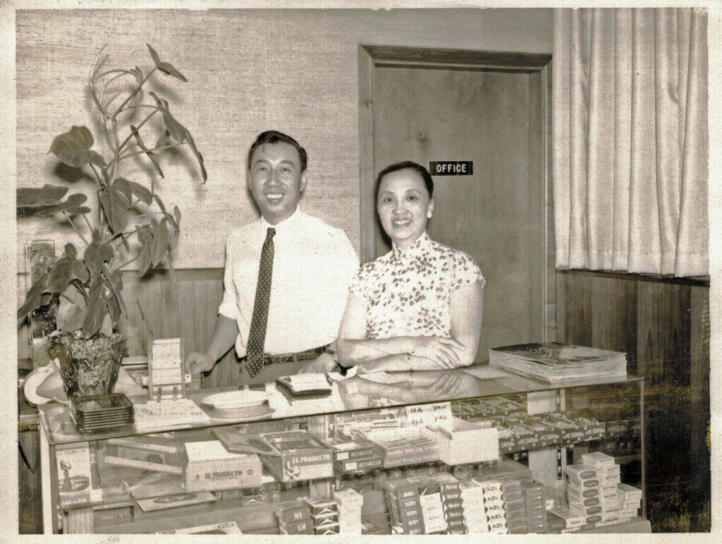 Man and a woman standing in front of a counter smiling