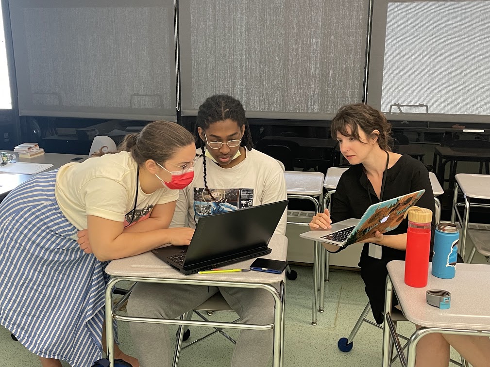A student in the Cambridge Harvard Summer Academy works with student teachers on a proposal for neighborhood improvements. 