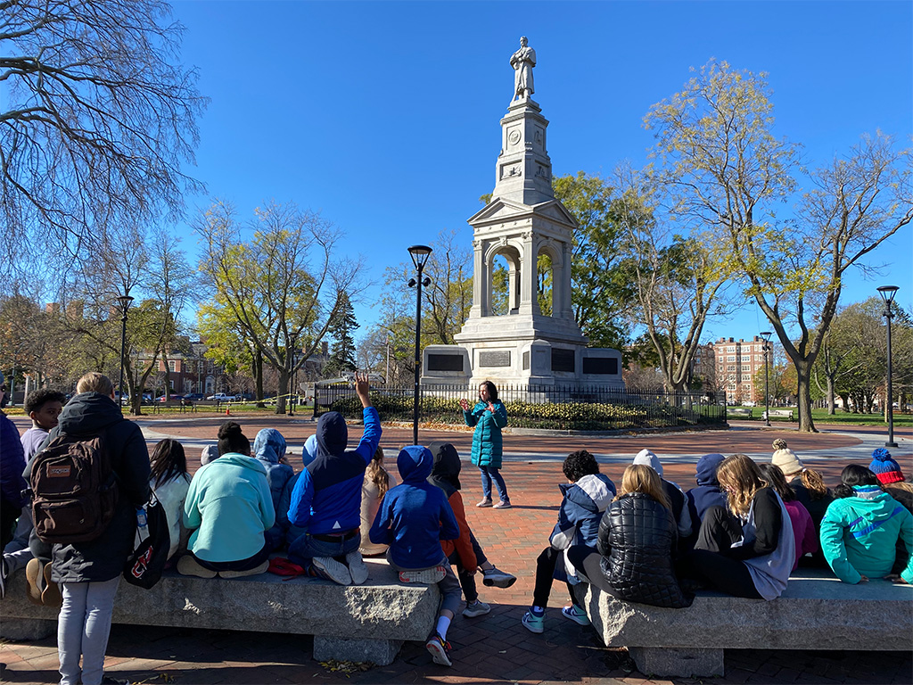 History Cambridge program manager Beth Folsom gives a tour of Cambridge Common monuments to students from BB&N Middle School. 
