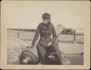 Marian Buckingham sitting on a cannon at Fort Washington commanding the Charles River April 1 1883