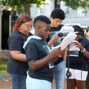 Community members take turns reading excerpts from Frederick Douglass’ “What to the Slave is the Fourth of July?”