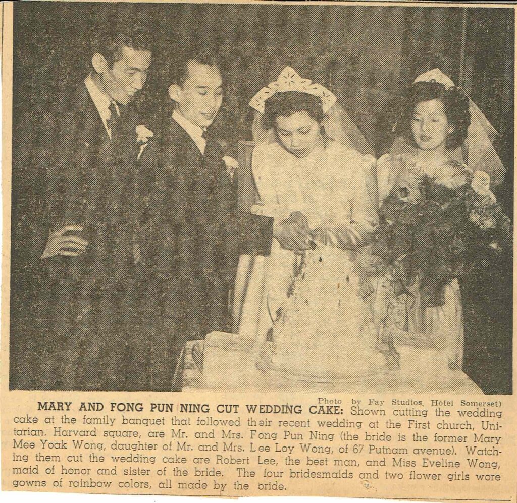 Newspaper clipping of two men and two women at a wedding cutting a cake