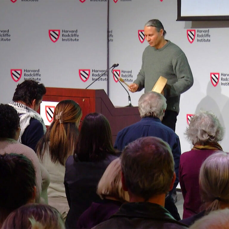 Larry Spotted Crow Mann of the Hassanamisco Nipmuc Band performs a hand drum honor song to open the Harvard Radcliffe Institute’s Responsibility and Repair Symposium on November 2nd 2023.