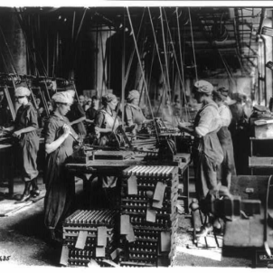 Women working in ordnance plants in World War I: spanner slotting fuse on head end of fuse bodies at Gray & Davis Co., Cambridge, Mass. Photo Credit: Library of Congress